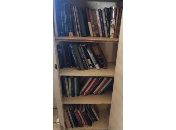 Four Shelves Of Hardcover And Paperback Books