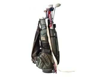 The Bushwacker II Golf Bag And Assortment Of Golf Clubs