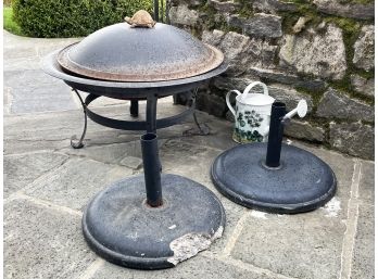 A Firepit, Umbrella Stands And Outdoor Accessories