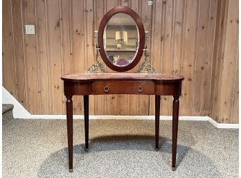 A Mahogany Vanity With Brass Details