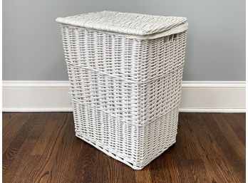A Wicker Laundry Hamper With Linen Liner
