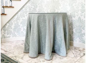 A Skirted Table With Glass Top