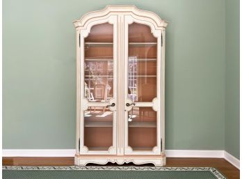 A Large Painted Wood Cabinet With Glass Paneled Doors