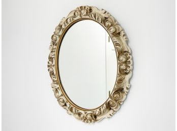 An Oval Mirror In Antique Style Frame