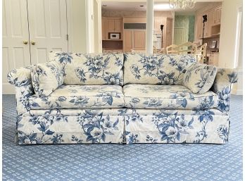 An Upholstered Sofa In Bright Blue Floral Print