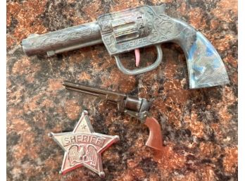 Sherriff's Badge, Pistol And A Small Cap Gun