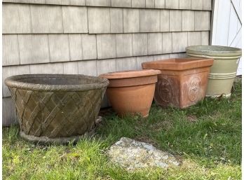 A Collection Of Four Glazed Ceramic And Terra Cotta Outdoor Planters