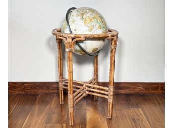 A Vintage Library Globe On Rattan Stand