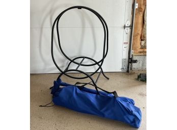 A Tubular Steel Wood Holder And Pair Of Collapsable Outdoor Chairs