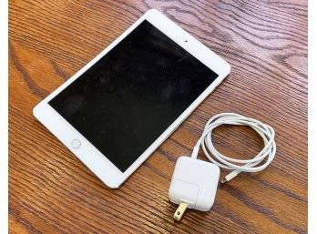 An Apple IPad And Charger