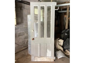 A Large Antique Paneled Wood Door With Marble Doorknob