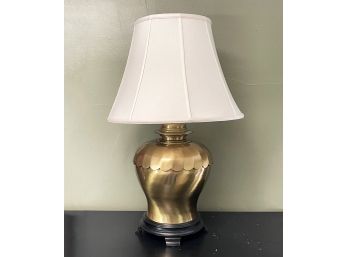 A Large Brass Lamp With Linen Shade