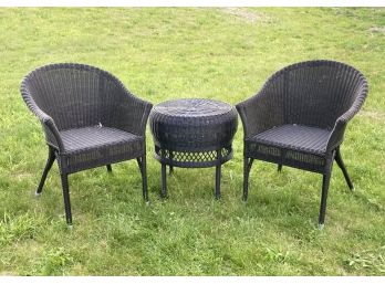 A Pair Of Outdoor Resin Arm Chairs And A Cocktail Table