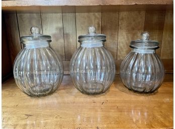 Three Large Lidded Glass Ribbed Jars