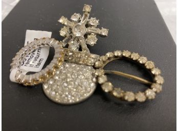 Rhinestone Ring, Sash, A Pin, A Single Earring And More.