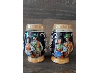 Lovely Pair Of Miniature German Steins With Raised Bavarian Chalets During Winter And Two Handsome Villagers