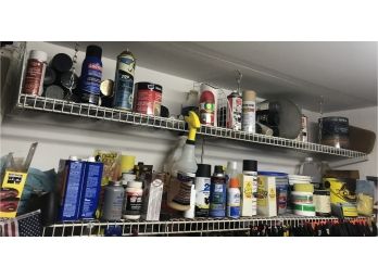 Two Shelves Of Assorted Paints And Products