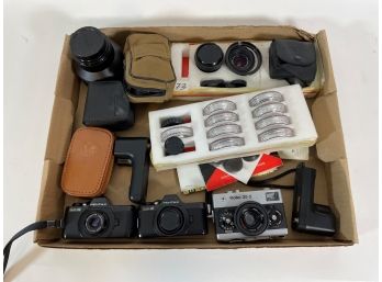CAMERA AND ACCESSORY LOT INCLUDES A RALEIGH 35S, TWO PENTAX AUTO110S, LENSES, FILTERS