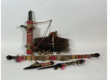 A GROUPING OF AFRICAN ITEMS. TWO DAGGERS, ONE BOW AND ARROW AND ONE HEADDRESS 28' AND SMALLER