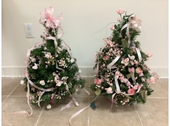Two Small Christmas Trees Decorated In Light Pink