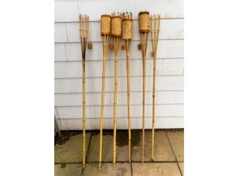 Four Tiki Torches And Two Holders