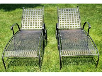 Two Black Wrought Metal Outdoor Chaise Lounge Chairs With Wheels