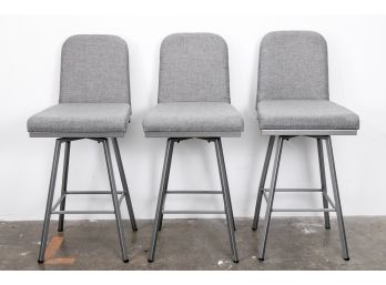 (77) Three Urban Grey Upholstered Swivel Counter Stools