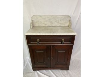 Marble Topped Cabinet On Casters With Backsplash And Black Tassel Knobs