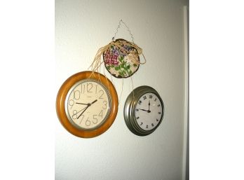 Two Wall Clocks And A Metal Wall Decoration