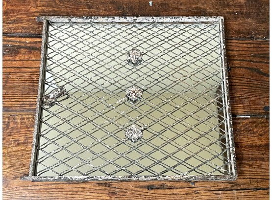 A Cast Iron Window Grate Over A Mirror