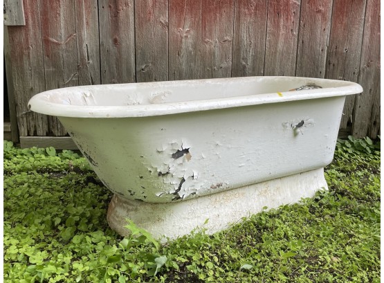 An Antique Cast Iron Bathtub With Apron Base