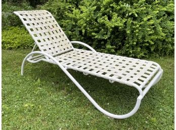 A Vintage Webbed And Tubular Aluminum Outdoor Lounge Chair