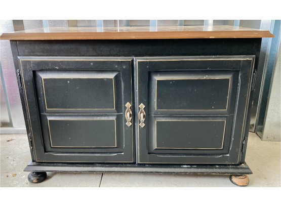Black Wooden Cabinet With Stenciling On Top