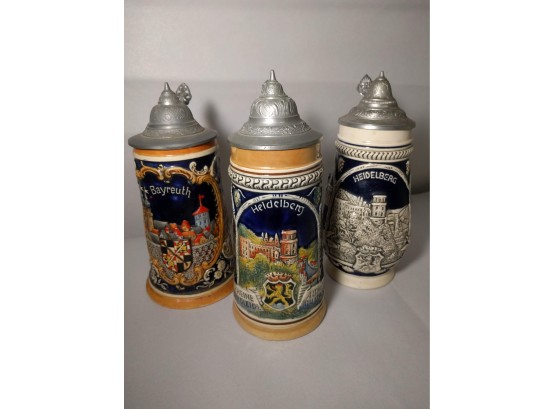 Pair Of German City Themed Ornamental Steins, And  A Free Third