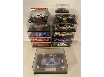 Assortment Of Cars In Display Cases