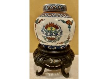 Very Nice Asian Ginger Jar Style Vessal With Lid On A Wooden Platform With Writing On The Bottom