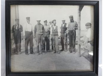 A Group Of Men Showing Off Fish They Caught