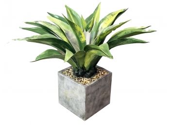 A Large Faux Plant In Modern Planter