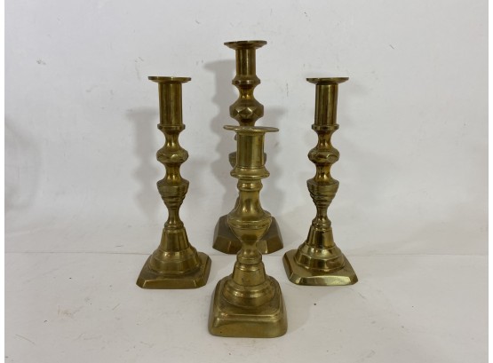 Group Of 4 Brass Candle Sticks Of Different Sizes