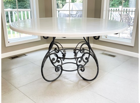 A Dining Table With Lacquered Top And Wrought Iron Base