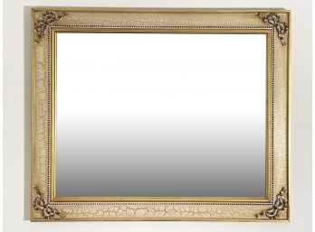 A Mirror In Faux Distressed And Gilt Wood Frame