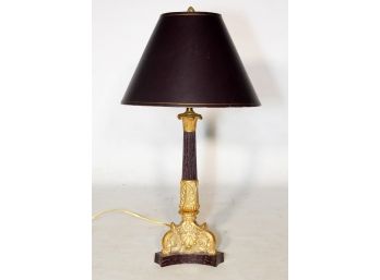 A Brass And Bronze Tone Lamp