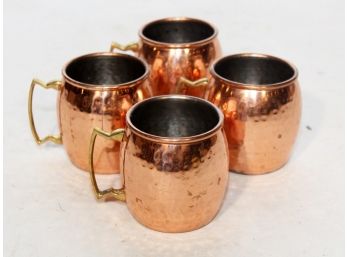 A Set Of 4 Hammered Copper Mule Mugs