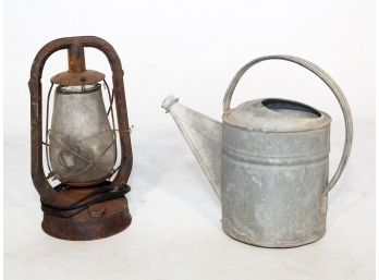 A Rustic Lantern And Watering Can