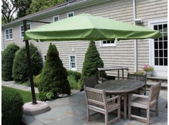 A Large Full Patio Tilt Umbrella By Front Gate With Sunbrella Fabric