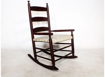 A Vintage Upholstered Ladder Back Rocking Chair