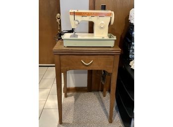 Singer Sewing Machine With A Sewing Table That Folds Open