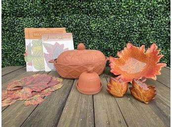 Terracotta Covered Casserole Dish, Garlic Cooker, And Decorative Leaves.