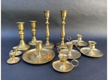 A Large Collection Of Brass Candlestick Holders