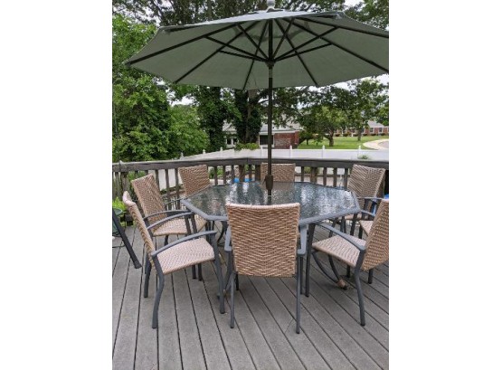 Octagonal, Glass-top Outdoor Table With Grey Base.  8 Wicker-style Vinyl Chairs And Matching Chaise.  Umbr